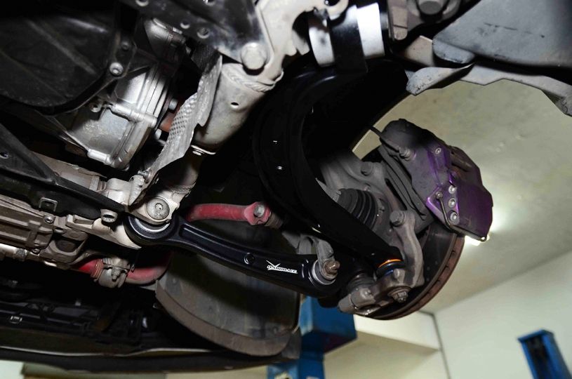 Close-up of a car's undercarriage with suspension components.