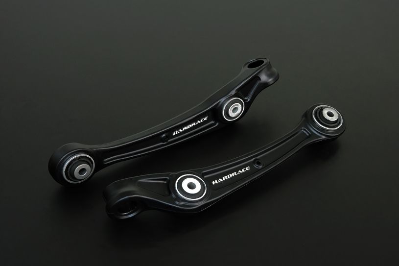Two black suspension control arms on a dark background