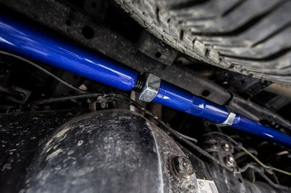 Close-up of a blue shock absorber on a vehicle's suspension system.