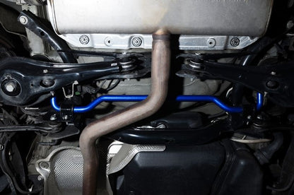 Close-up of a car's undercarriage with suspension components and exhaust system.