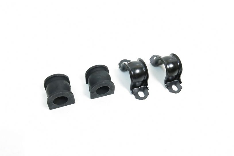 Four black rubber bushings on a white background