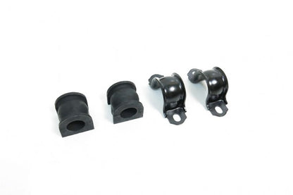 Four black rubber bushings on a white background