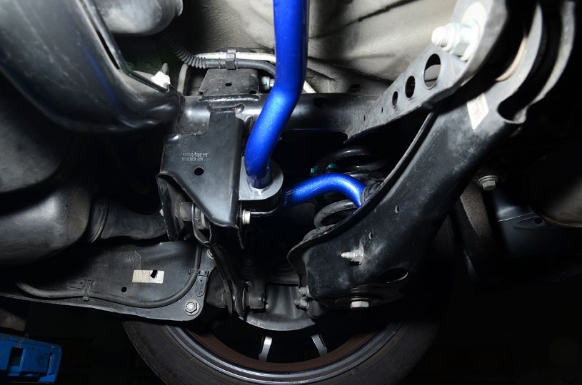 Close-up of a vehicle's suspension system with a blue component.