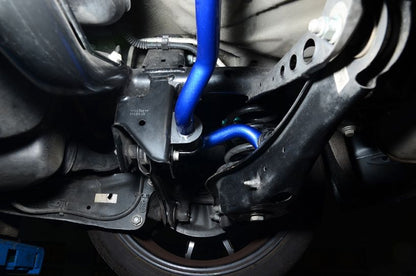 Close-up of a vehicle's suspension system with a blue component.