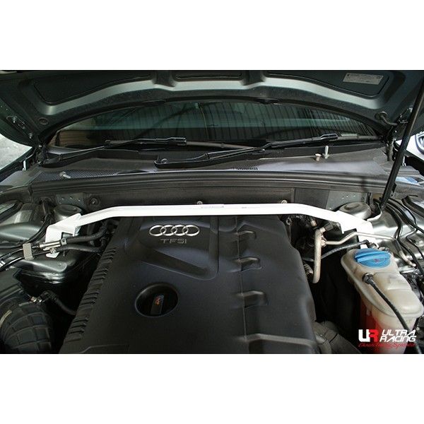 Car engine with a white strut bar on an Audi vehicle, featuring Ultra Racing branding.